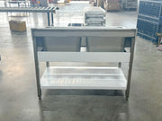 Stainless steel commercial kitchen worktable with dual sinks and storage shelf